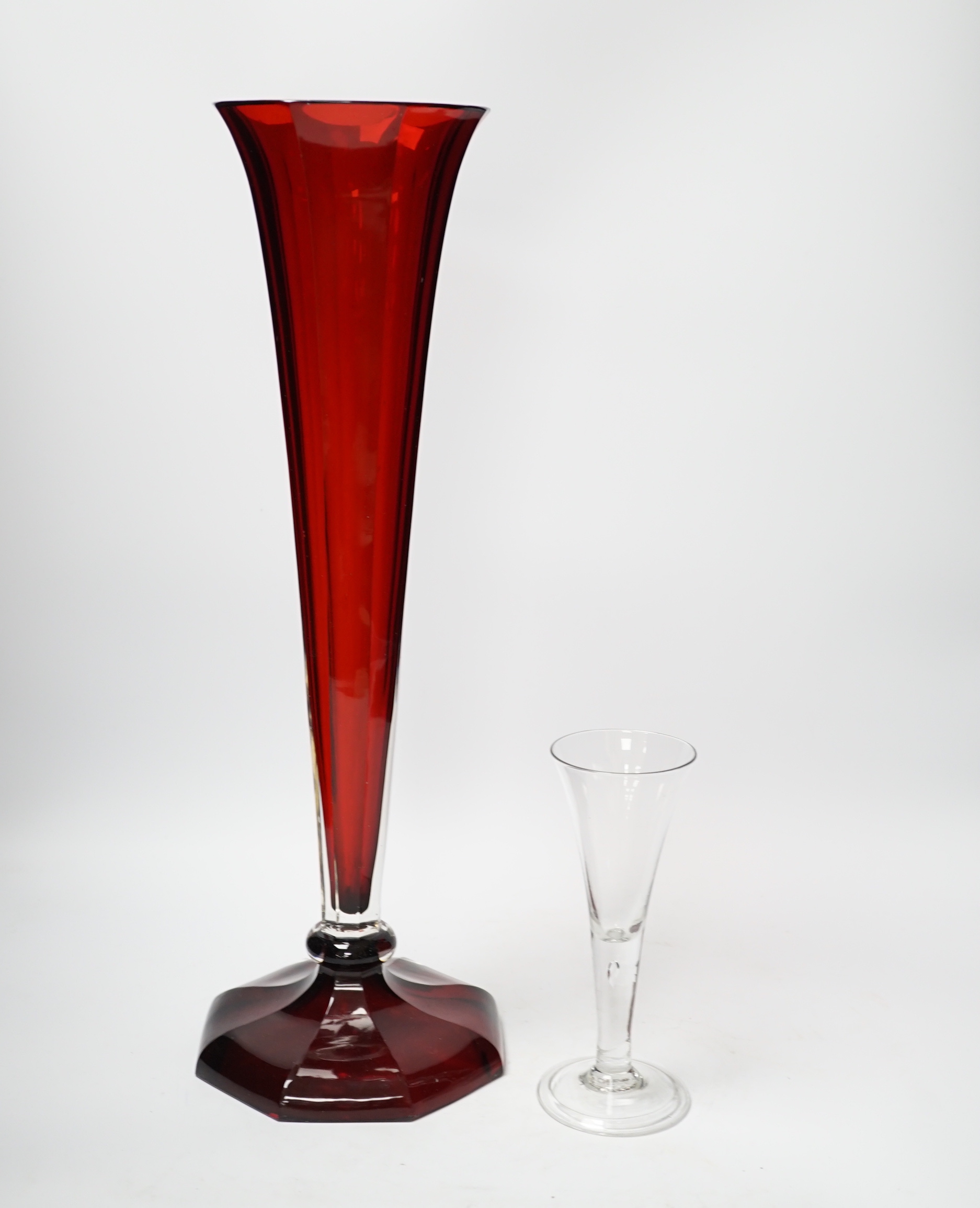 A large Bohemian ruby flashed glass lily vase and a mid-18th century ‘drawn trumpet’ cordial glass with air tear